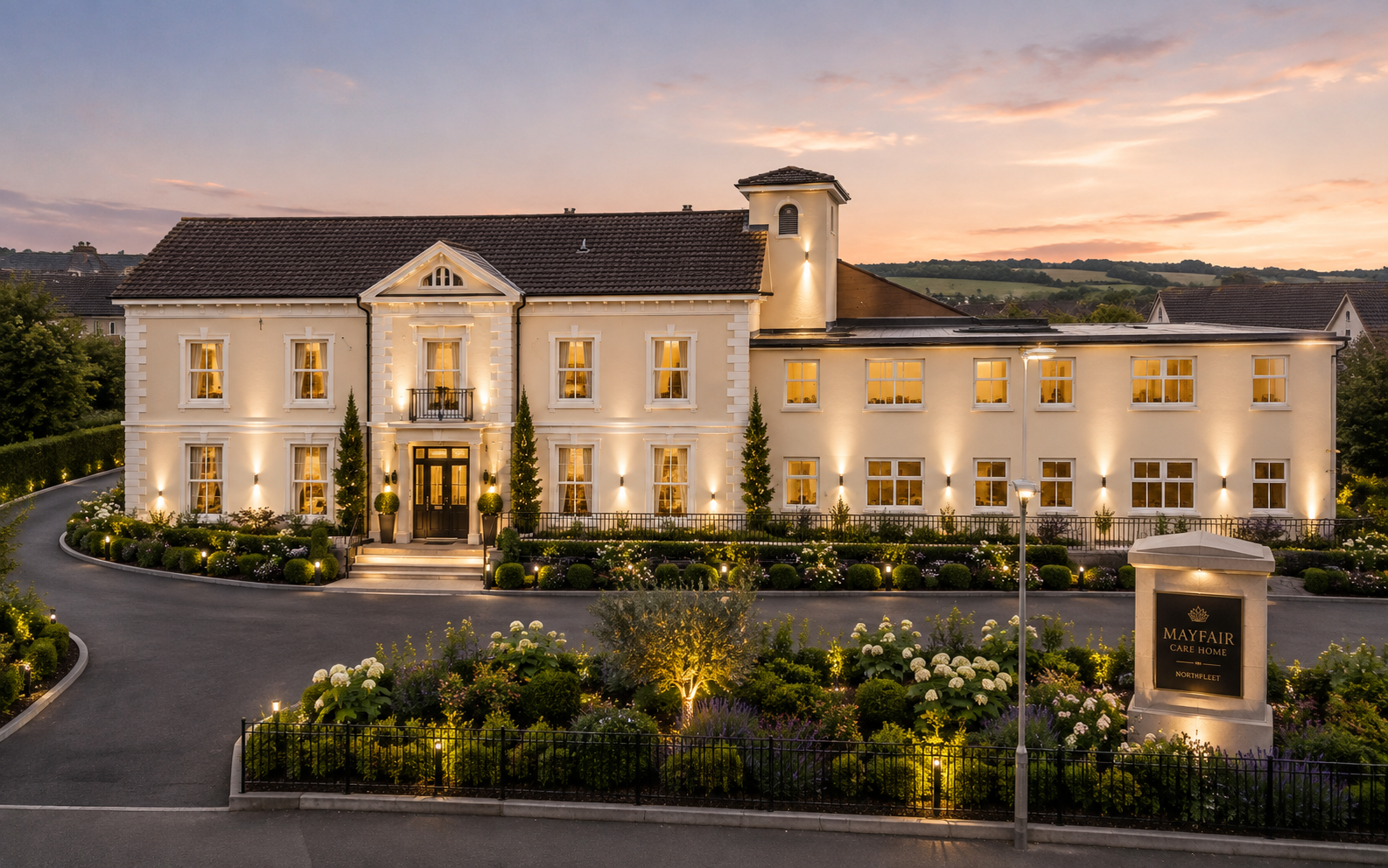 The front elevation of Mayfair Care Home, Northfleet, illuminated at dusk
